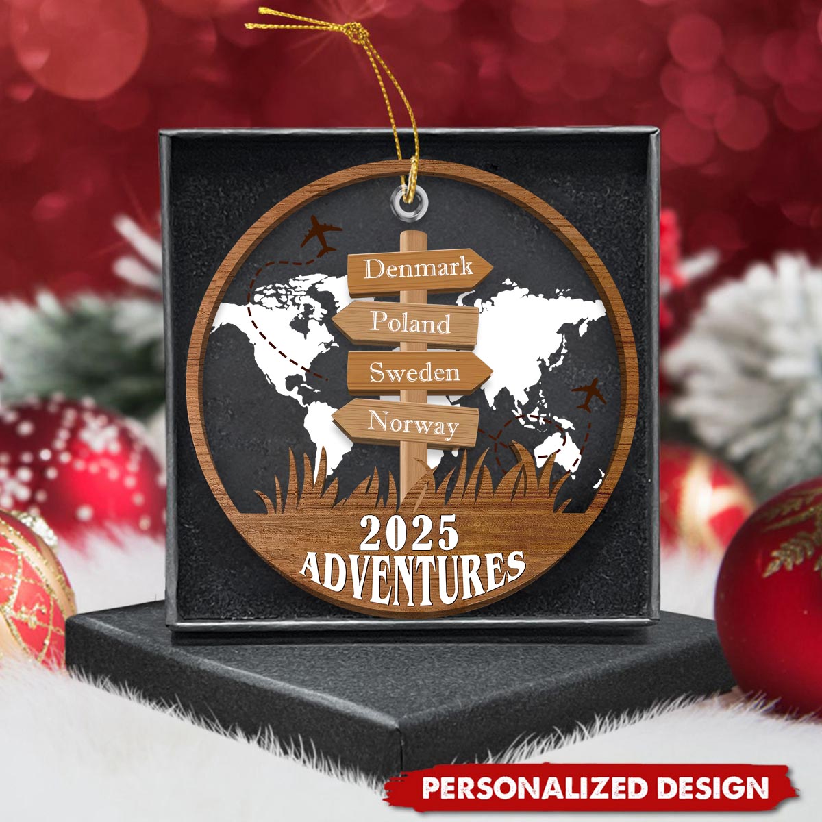 The travel ornament presented in a box among Christmas baubles